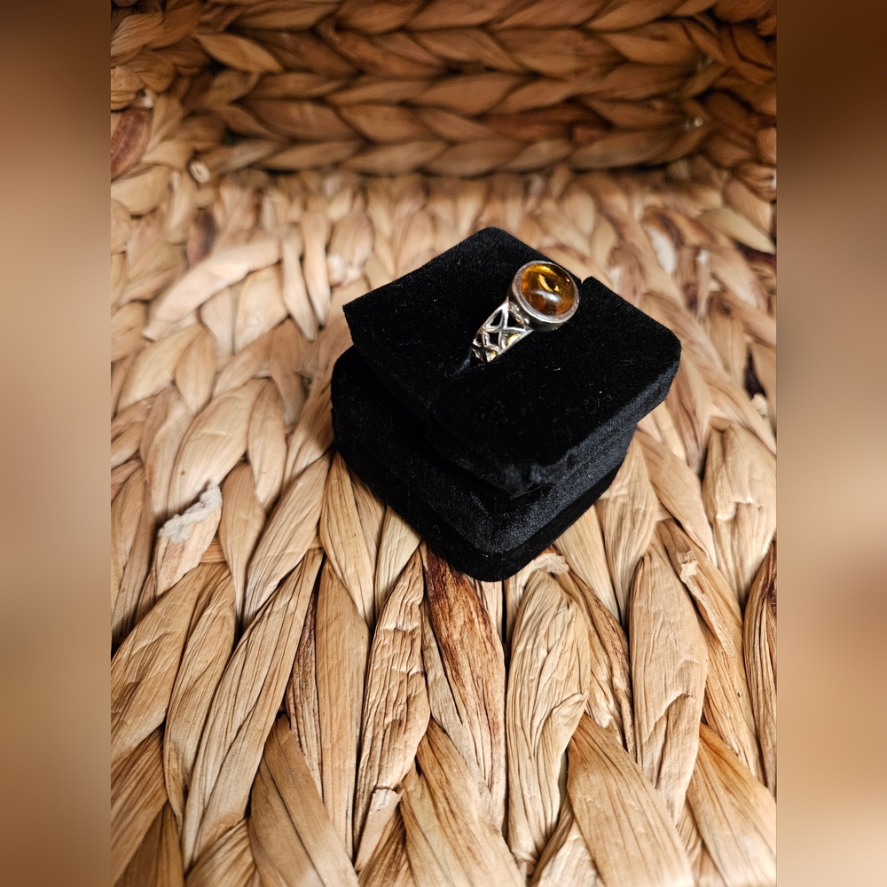 Elegant Round Amber Stone Ring With Intricate Design On The Silver Band
